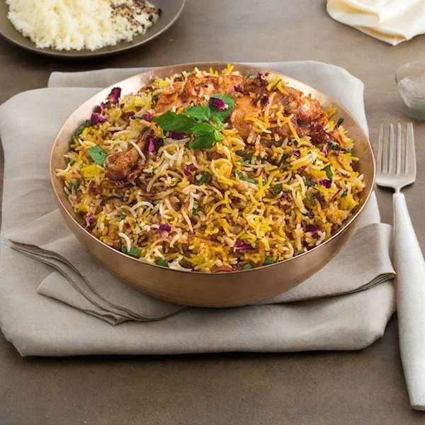 Fragrant chicken biryani in a traditional copper Handi sealed with dough — Dum cooking method