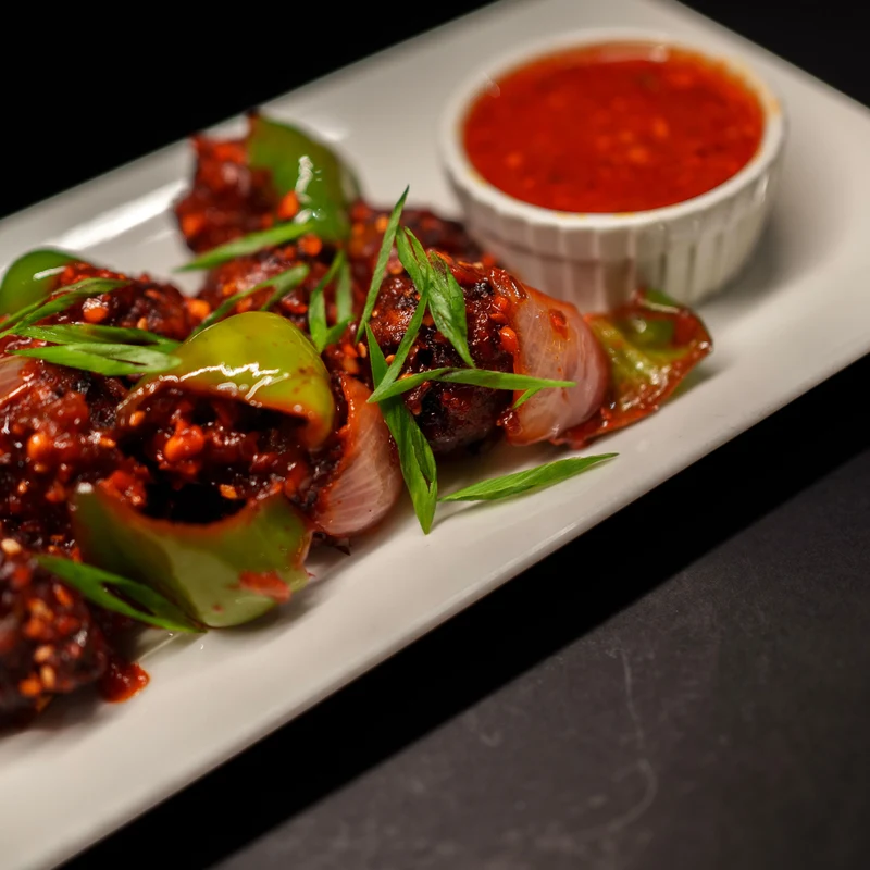 Indo-Chinese chilli chicken tossed with peppers and soy sauce